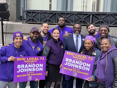 Chicago Mayor Brandon Johnson poses for a photo with members of